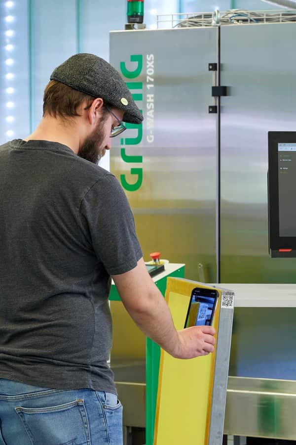 Operator scanning a job code in a digital screen-making workflow Operator scanning a job code in a digital screen-making workflow